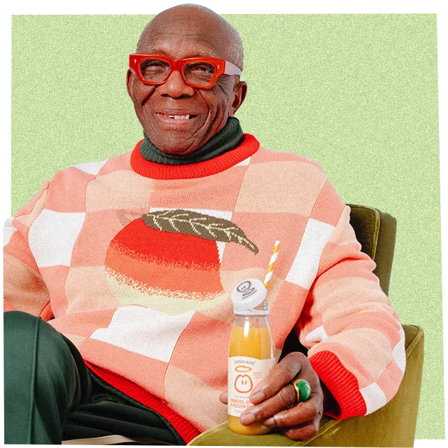man wearing big  knitwear jumper and drinking an innocent smoothie
